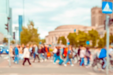 People walking on city street, blurred view