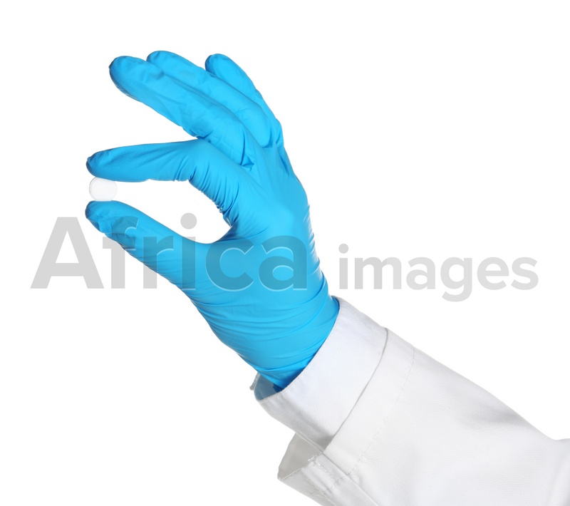Doctor in medical glove holding pill on white background