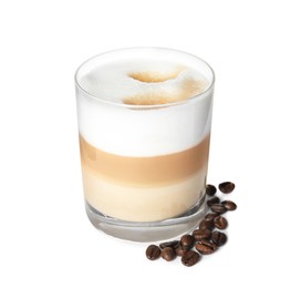 Delicious latte macchiato and coffee beans on white background