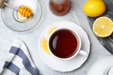 Photo of Flat lay composition of tea with honey on light grey marble table