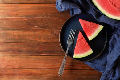 Sliced fresh juicy watermelon served on wooden table, flat lay. Space for text