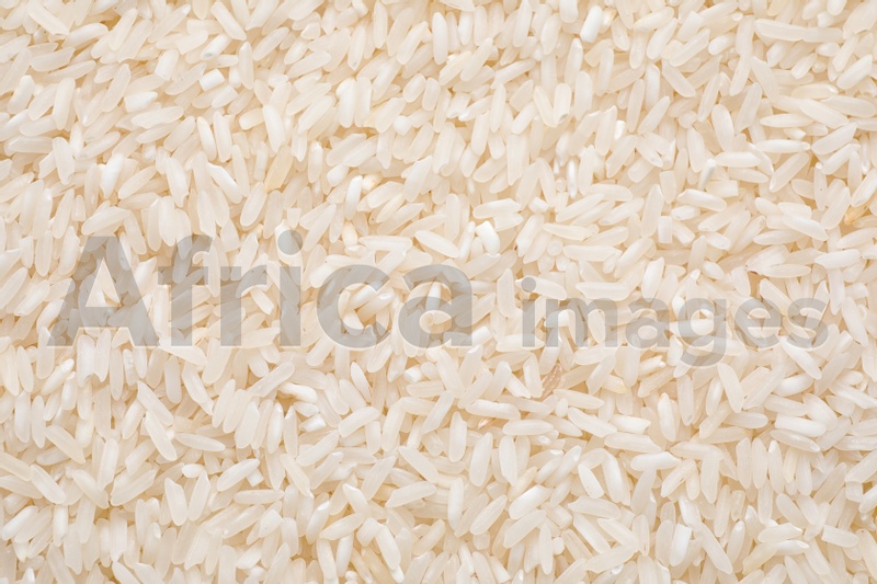 Pile of polished rice as background, top view
