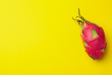 Delicious pitahaya fruit on yellow background, top view. Space for text