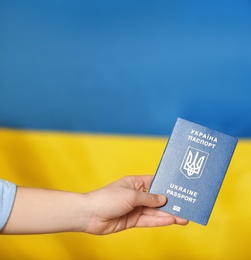 Woman with Ukrainian travel passport voting abroad, closeup. International relationships