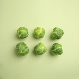 Fresh Brussels sprouts on green background, flat lay