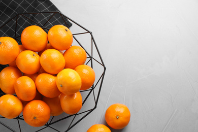 Fresh ripe tangerines on light grey table, flat lay. Space for text