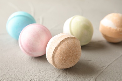 Photo of Colorful bath bombs on grey background. Spa product
