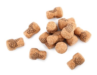 Heap of sparkling wine corks on white background, top view