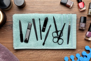 Photo of Flat lay composition with set of manicure tools on wooden table