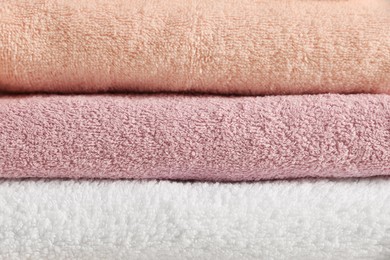 Dry soft folded towels as background, closeup