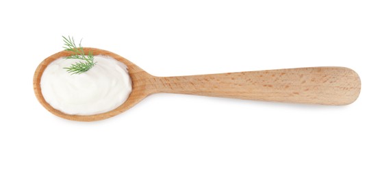 Delicious sour cream with dill in wooden spoon on white background, top view