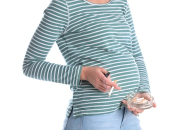 Young pregnant woman smoking cigarette on white background, closeup. Harm to unborn baby