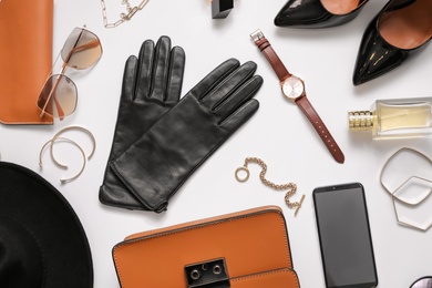 Flat lay composition with stylish black leather gloves, shoes and accessories on white background