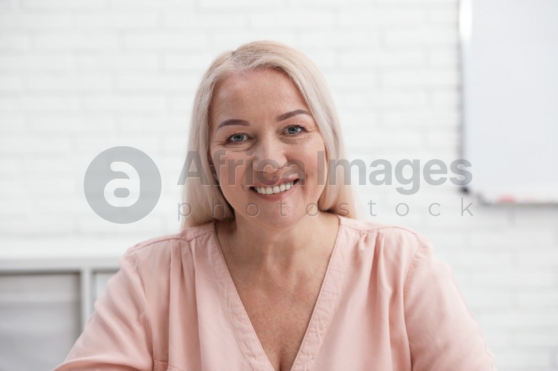 Photo of Mature woman using video chat in office, view from web camera