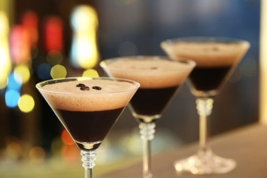 Glasses of delicious Espresso Martini on blurred background. Alcohol cocktail
