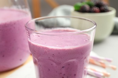 Delicious blackberry smoothie in glass, closeup view