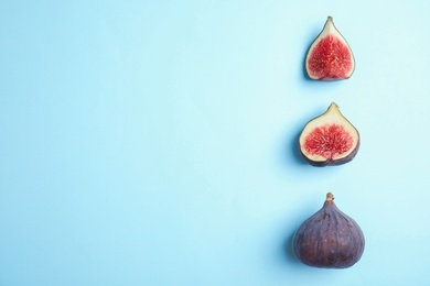 Delicious ripe figs on light blue background, flat lay. Space for text