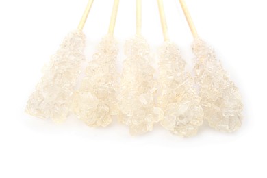 Wooden sticks with sugar crystals isolated on white, closeup. Tasty rock candies