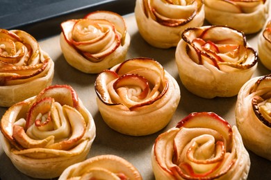 Photo of Tray with freshly baked apple roses, closeup. Beautiful dessert