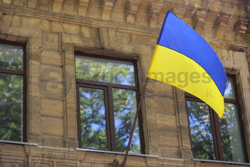 National flag of Ukraine on old building wall outdoors