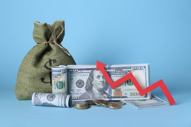 Economic profit. Money bag, coins, banknotes and arrow on light blue background
