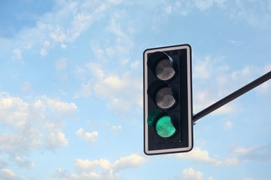Traffic light against blue sky, space for text