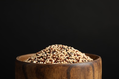 Bowl with mixed quinoa seeds on black background, closeup. space for text