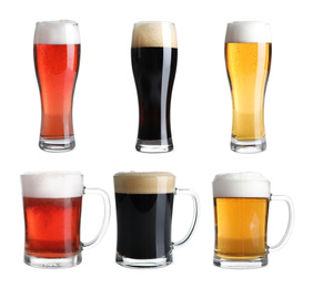 Set with glasses of cold tasty beer on white background