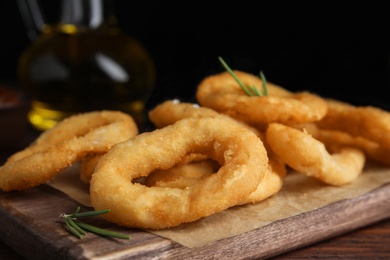 Fried onion rings served on wooden table, closeup