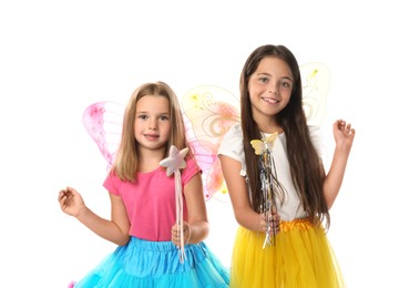 Cute little girls in fairy costumes with wings and magic wands on white background