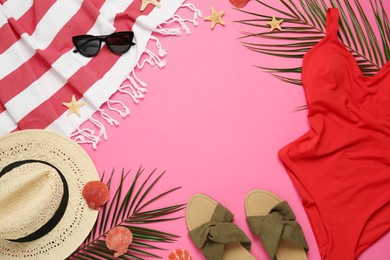 Frame made with different beach objects on pink background, flat lay. Space for text