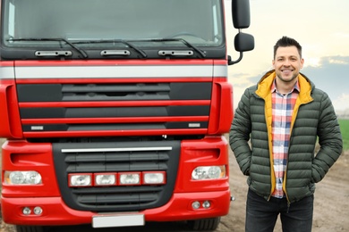 Portrait of driver at modern truck outdoors