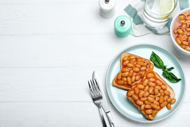 Toasts with delicious canned beans on white wooden table, flat lay. Space for text