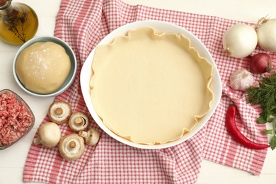 Photo of Flat lay composition with raw dough and ingredients on white wooden table. Baking meat pie