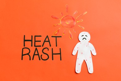 Words Heat Rash, human cutout and sun on orange background, flat lay