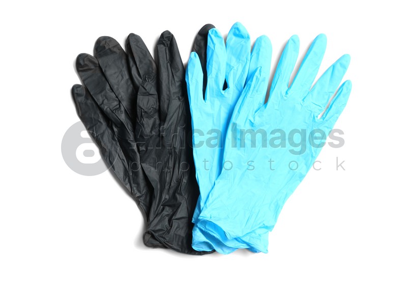 Different medical gloves on white background, top view