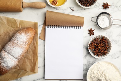 Blank recipe book, cooking utensils and ingredients on white marble table, flat lay. Space for text