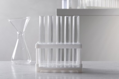 Set of laboratory glassware on white wooden table indoors