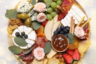 Photo of Assorted appetizers on white wooden table, top view