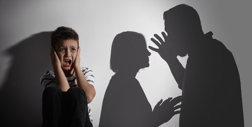 Scared little boy closing his ears and silhouettes of arguing parents. Banner design