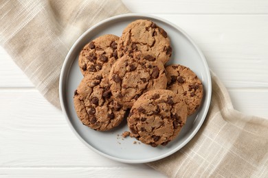 Photo of Delicious chocolate chip cookies on white wooden table, top view