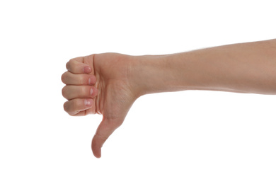 Man showing thumb down gesture against white background, closeup of hand