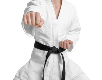 Martial arts master in keikogi with black belt against white background, focus on fist