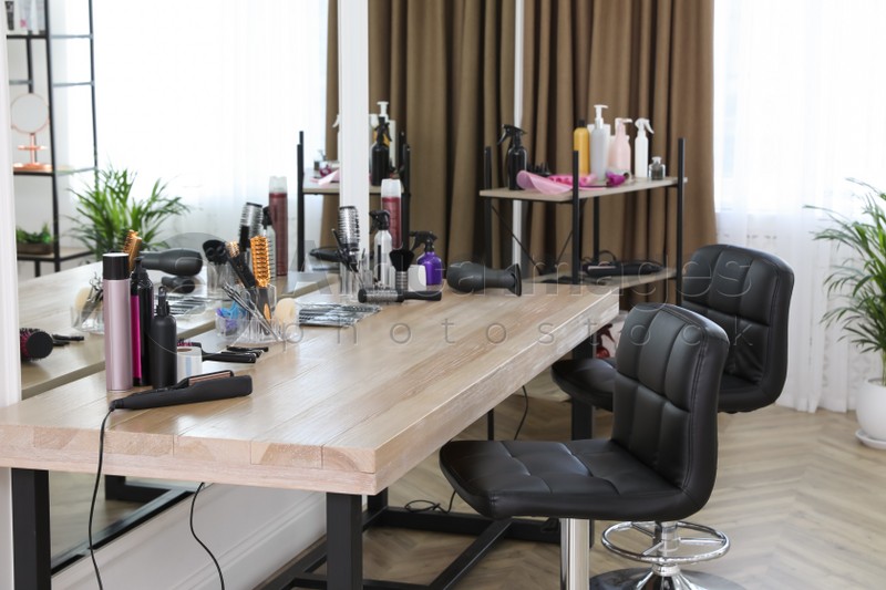 Stylish beauty salon interior with hairdresser's workplace