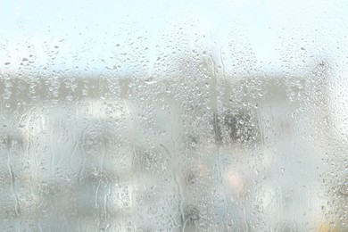 Photo of Window glass with raindrops as background, closeup