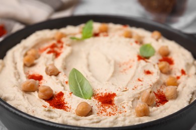 Delicious hummus with chickpeas and paprika, closeup