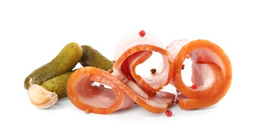 Slices of delicious smoked bacon with peppercorns, garlic and pickled cucumbers on white background