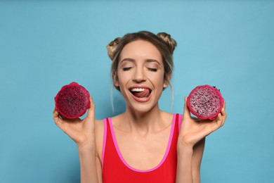 Photo of Young woman with fresh pitahaya on light blue background. Exotic fruit