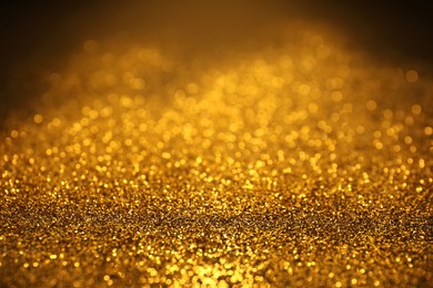 Photo of Shiny golden glitter as background. Bokeh effect