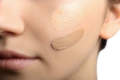 Photo of Girl on white background, closeup. Using concealer and foundation for face contouring